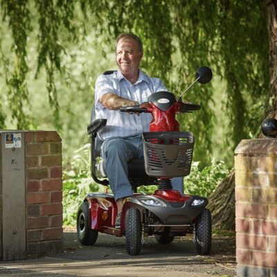 a man riding a mobility scooter on the street