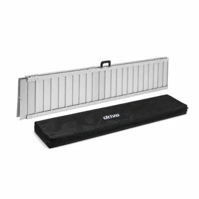 Wheelchair ramp folded beside its black Drive travel bag