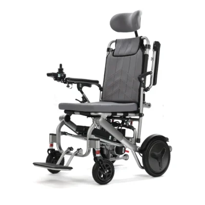 Explorer Air reclining electric wheelchair at an angle with headrest fitted